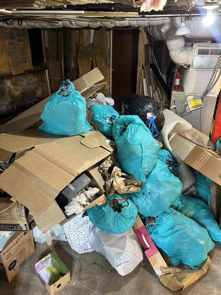 Basement cleanout in progress with bagged junk and boxes